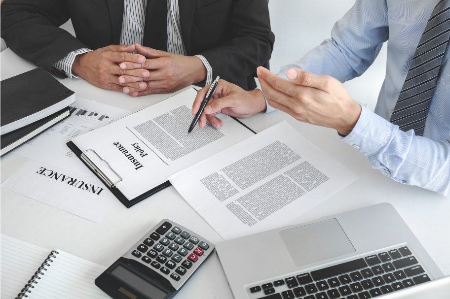 Two people sitting down looking at business insurance policies